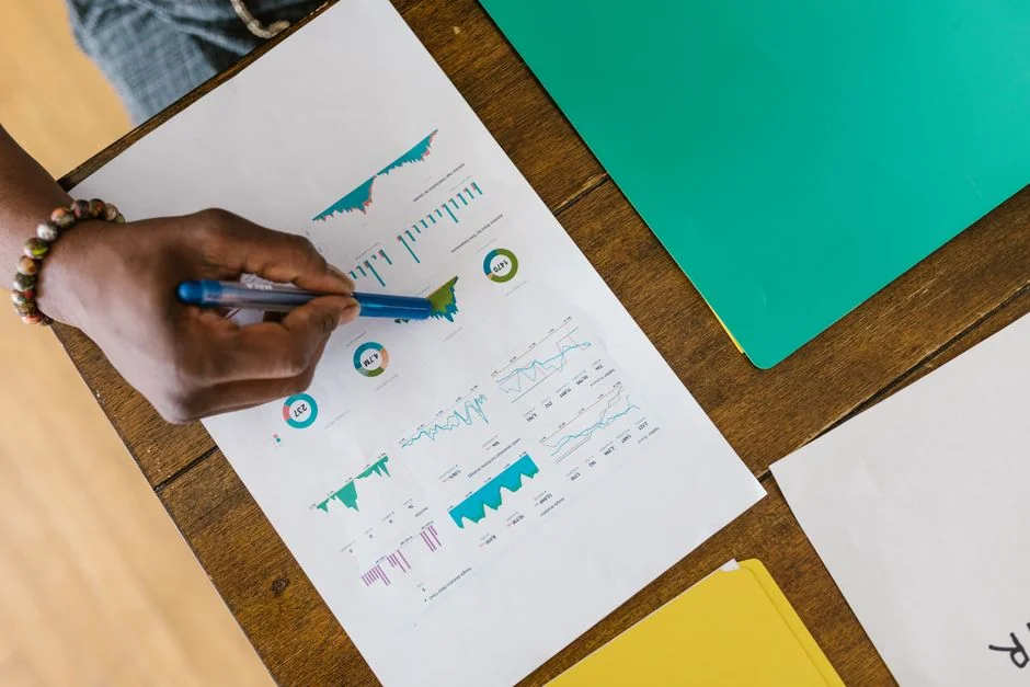 Two colleagues collaborate on a marketing strategy using a whiteboard, focusing on user-generated content.